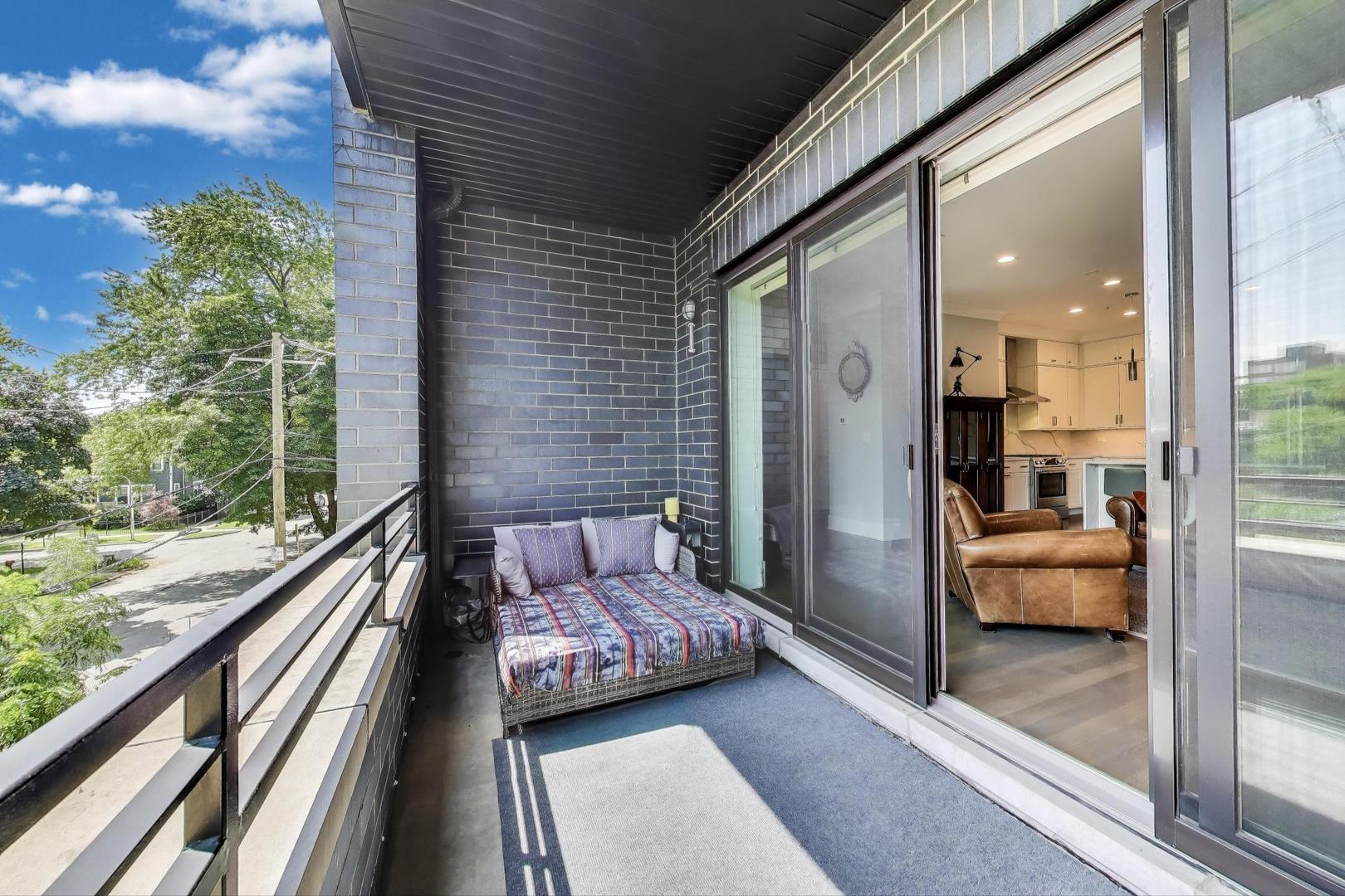 5748 North Hermitage Avenue, Unit 206 Chicago, IL 60660 - Photo 9 of 19 a balcony view with a couch and wooden floor