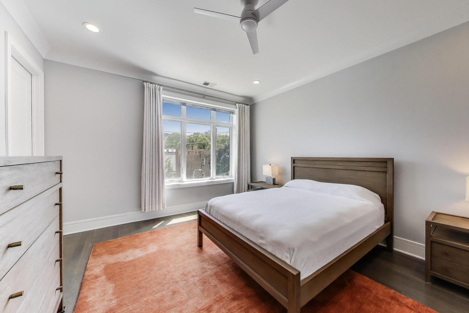 5748 North Hermitage Avenue, Unit 206 Chicago, IL 60660 - Photo 10 of 19 a bed sitting in a spacious bedroom next to a window