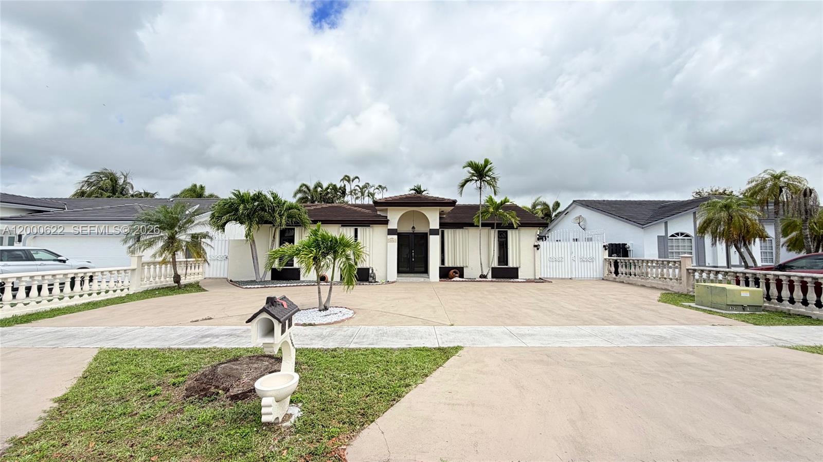 14861 Southwest 173rd Street Miami, FL 33187 - Photo 1 of 24 a front view of a house with garden