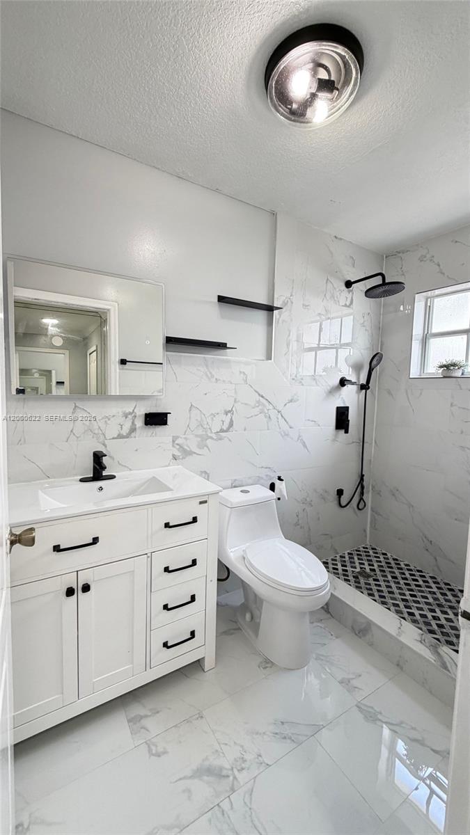 14861 Southwest 173rd Street Miami, FL 33187 - Photo 11 of 24 a bathroom with a toilet sink and mirror