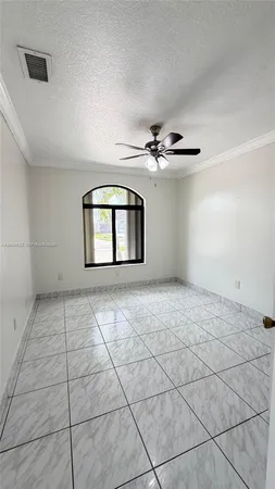 a view of a livingroom with a chandelier fan and furniture