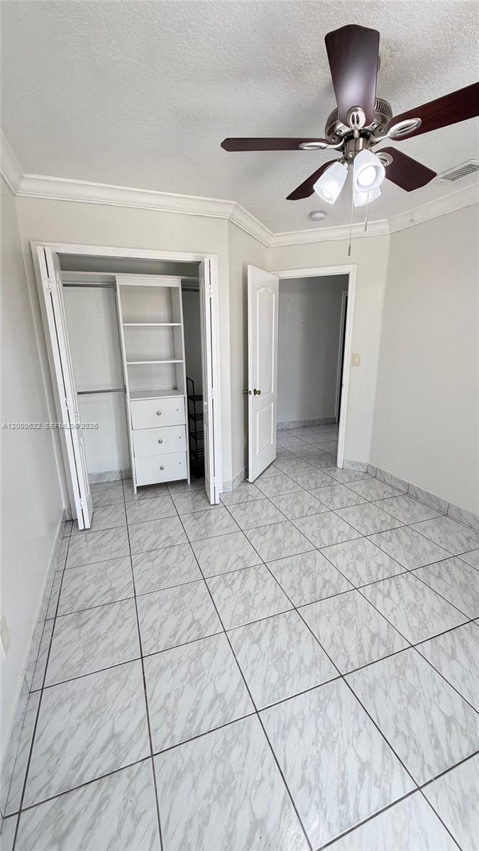 14861 Southwest 173rd Street Miami, FL 33187 - Photo 14 of 24 a view of room with a ceiling fan and window