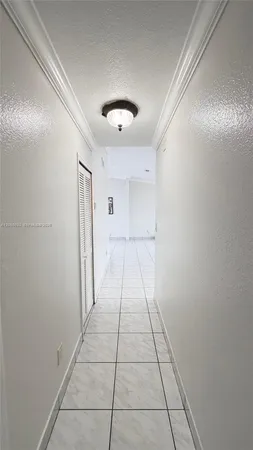 a large kitchen with cabinets a sink and white appliances