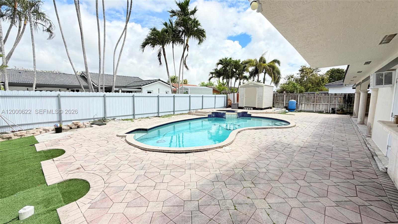 14861 Southwest 173rd Street Miami, FL 33187 - Photo 24 of 24 a view of a swimming pool with a garden