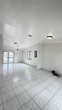 a view of a room with a window and chandelier