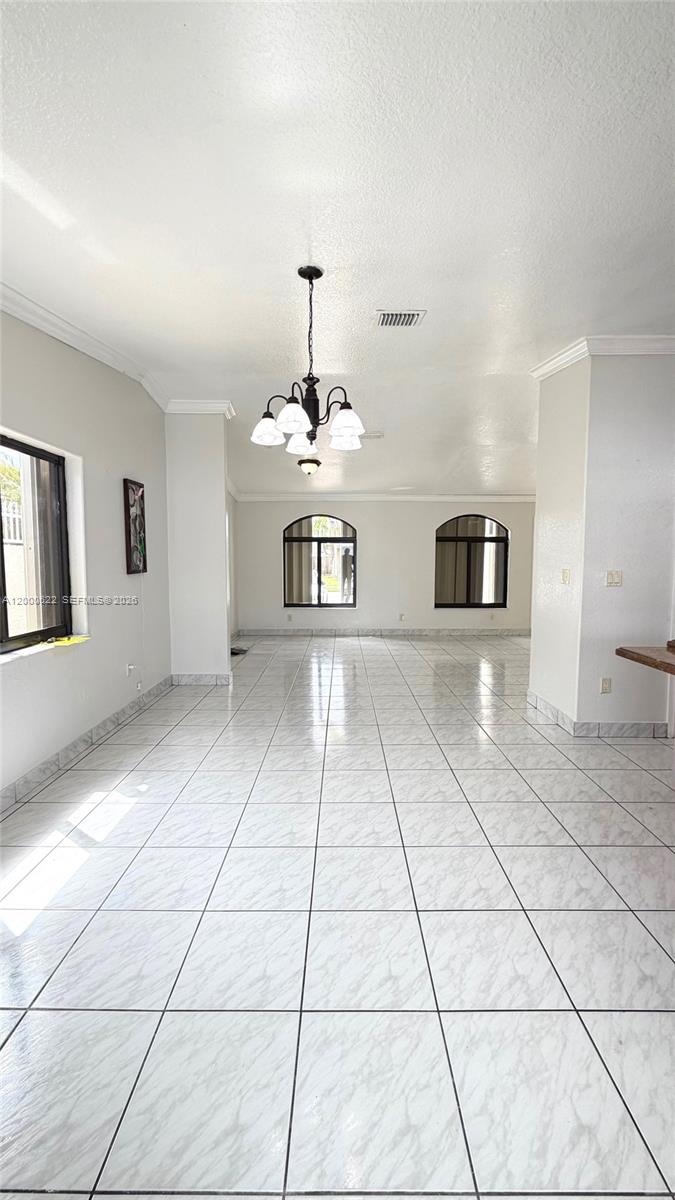 14861 Southwest 173rd Street Miami, FL 33187 - Photo 4 of 24 a view of a room with a window and chandelier