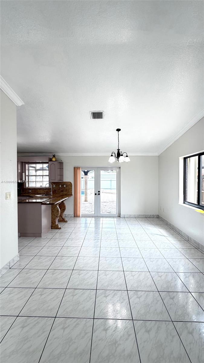 14861 Southwest 173rd Street Miami, FL 33187 - Photo 5 of 24 a view of a kitchen with furniture and cabinets