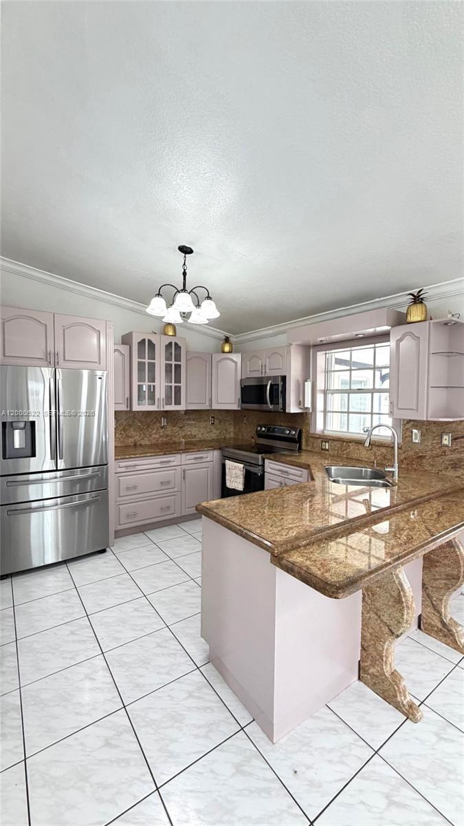 14861 Southwest 173rd Street Miami, FL 33187 - Photo 6 of 24 a kitchen with stainless steel appliances granite countertop a sink and cabinets