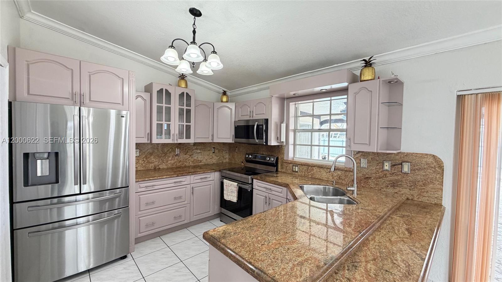 14861 Southwest 173rd Street Miami, FL 33187 - Photo 7 of 24 a kitchen with stainless steel appliances granite countertop a stove top oven a refrigerator a sink and dishwasher