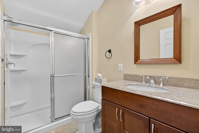 a front view of a house with a yard and potted plants