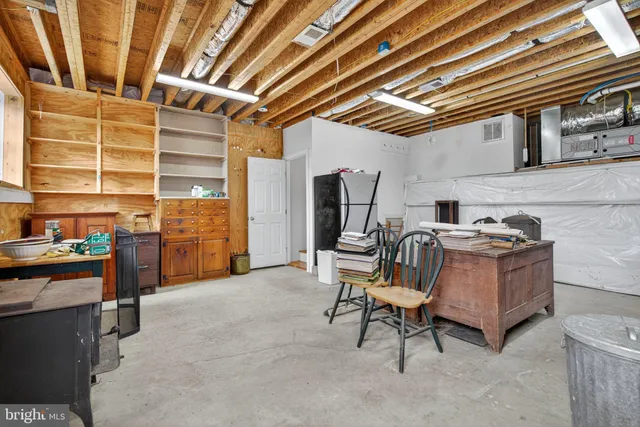 a view of room with stairs and furniture