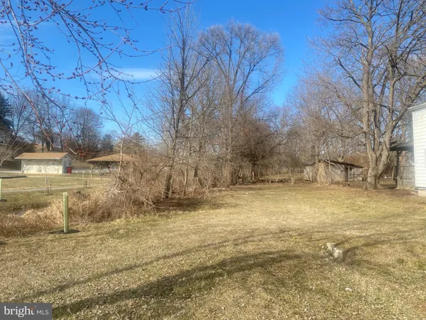 a view of yard covered with snow in front of house