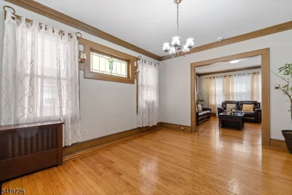 a view of a livingroom with furniture window and wooden floor