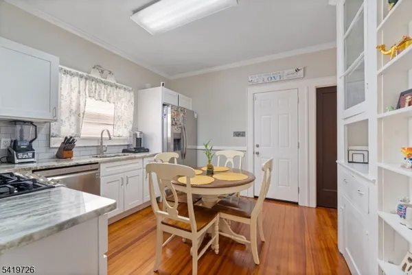 a view of a dining room with furniture and wooden floor