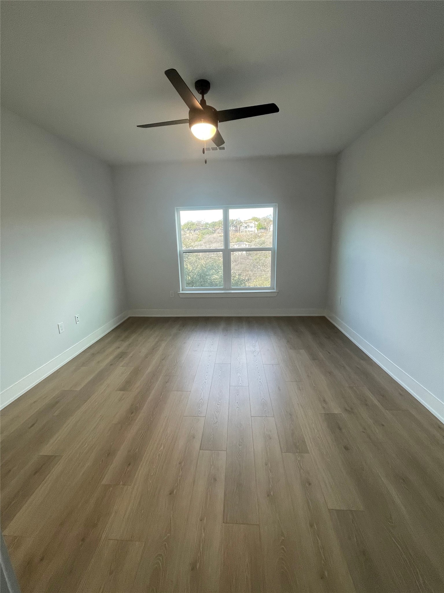 2500 Longview Street, Unit 400 Austin, TX 78705 - Photo 4 of 14 an empty room with wooden floor and windows