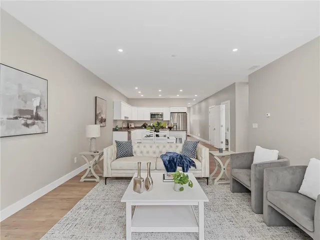a living room with furniture and kitchen view