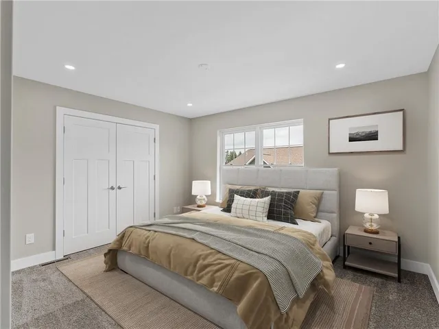 a bedroom with a bed and a couch