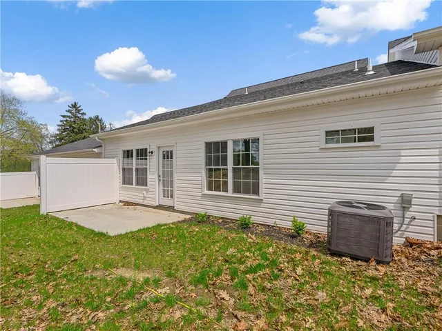 a backyard of a house with yard and outdoor seating