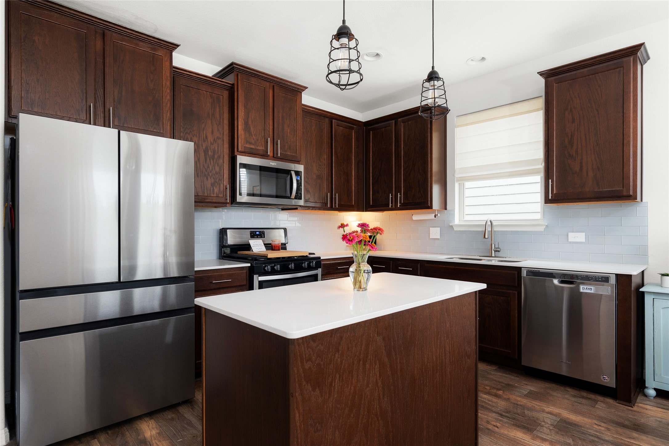 249 Wapiti Road Buda, TX 78610 - Photo 10 of 21 A contemporary culinary space with abundant rich wood cabinetry and a central island.
