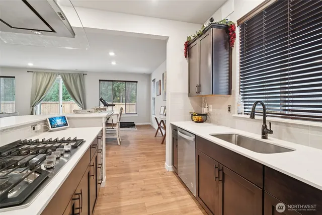 a kitchen with sink stove and cabinets