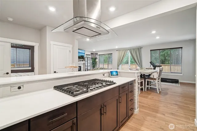 a kitchen with lots of counter top space and wooden floor
