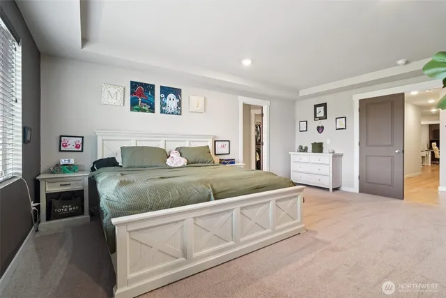 a bedroom with a bed and a view of kitchen