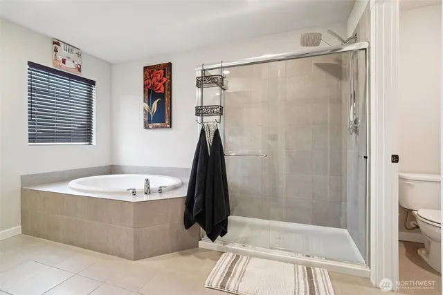 a bathroom with a tub a sink and a shower