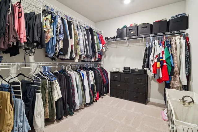 a view of walk in closet with clothes