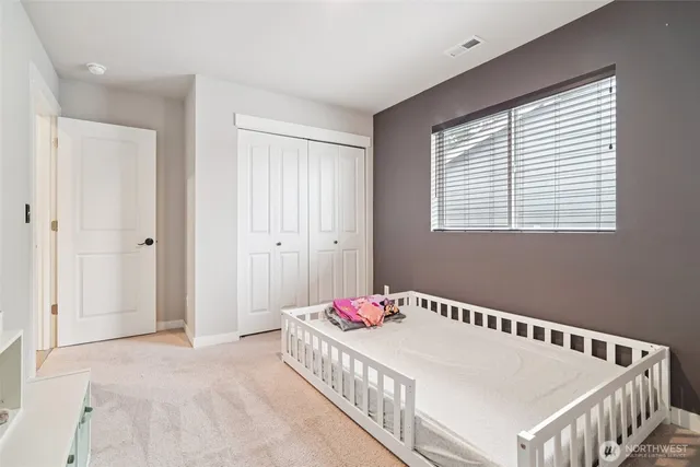 a bedroom with bed and a window