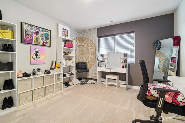 a view of a workspace with furniture and a window