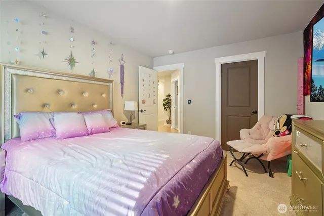 a bedroom with a bed and chair