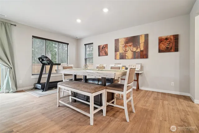 a dining room with furniture and wooden floor