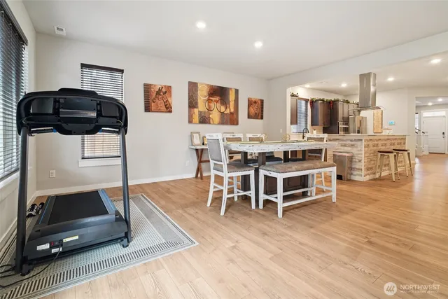 a view of a dining room with furniture and wooden floor