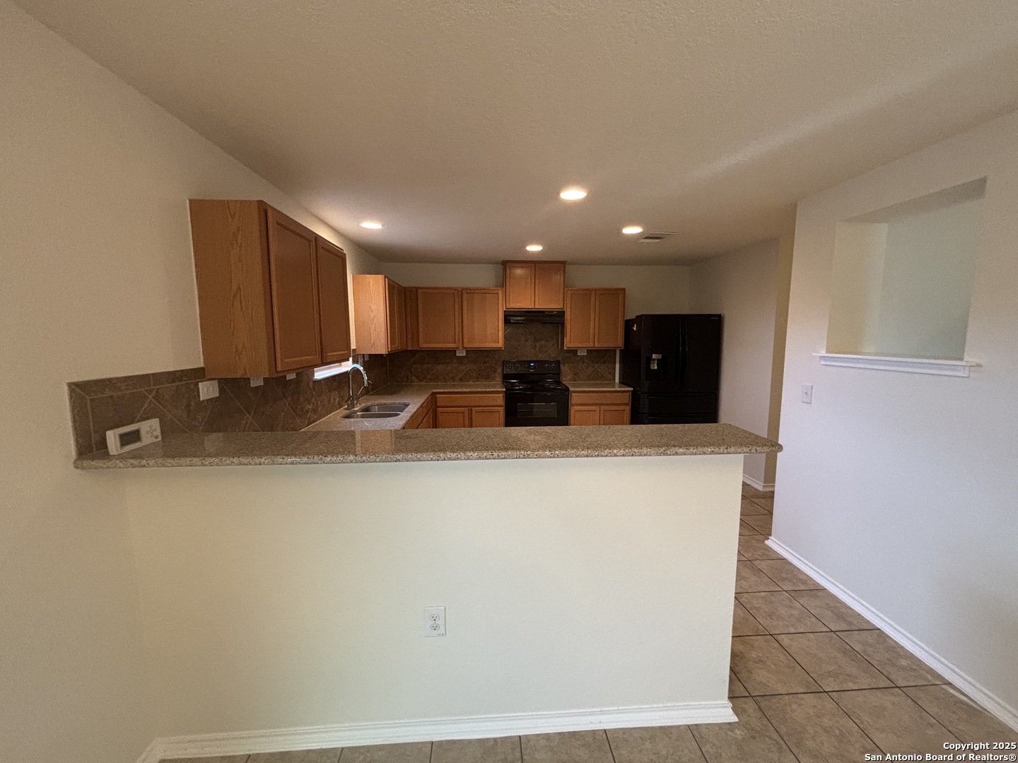 7370 Azalea Square San Antonio, TX 78218 - Photo 19 of 38 a view of kitchen with stainless steel appliances granite countertop refrigerator sink and stove