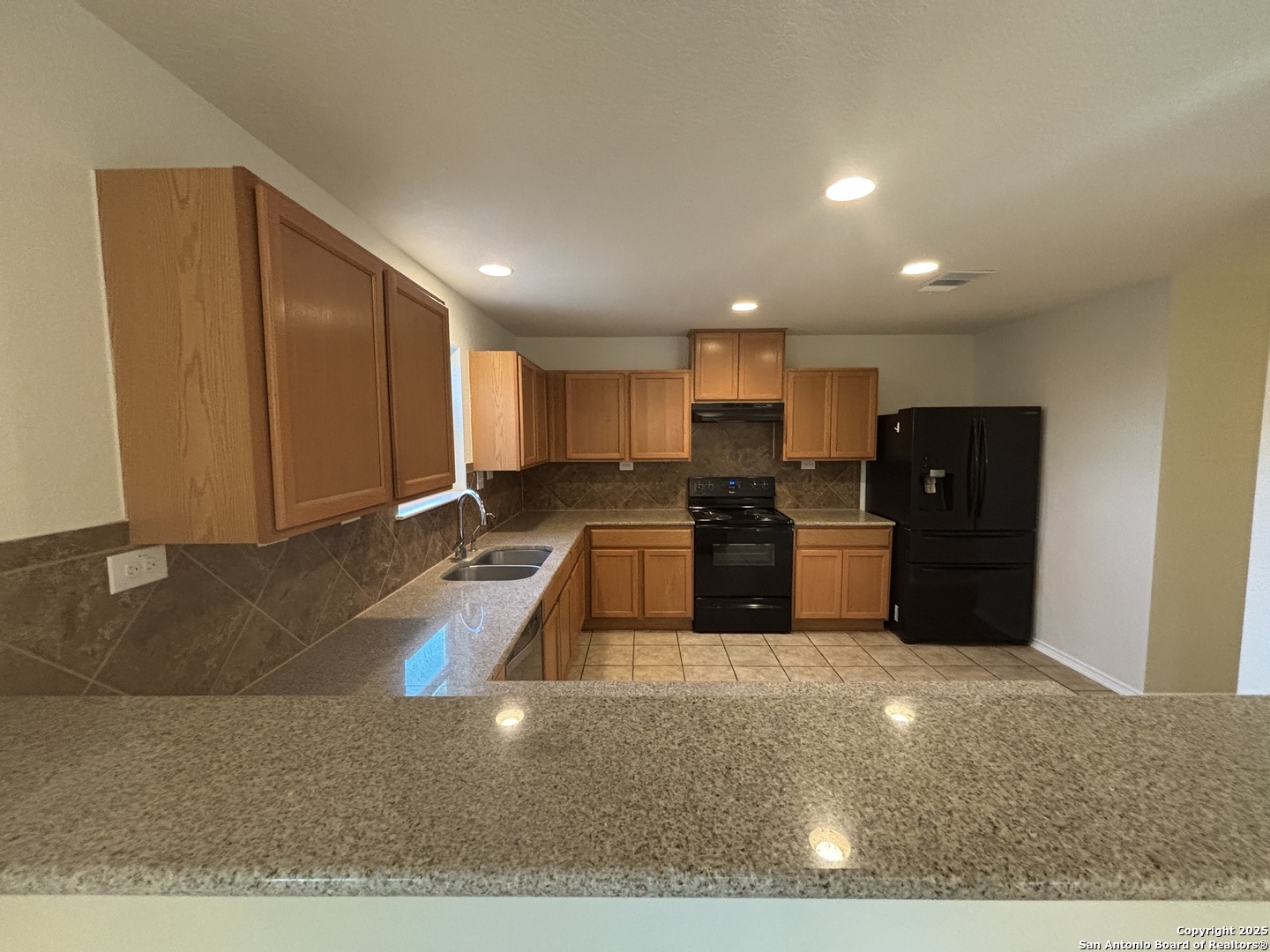 7370 Azalea Square San Antonio, TX 78218 - Photo 20 of 38 a kitchen with stainless steel appliances granite countertop a refrigerator and a sink