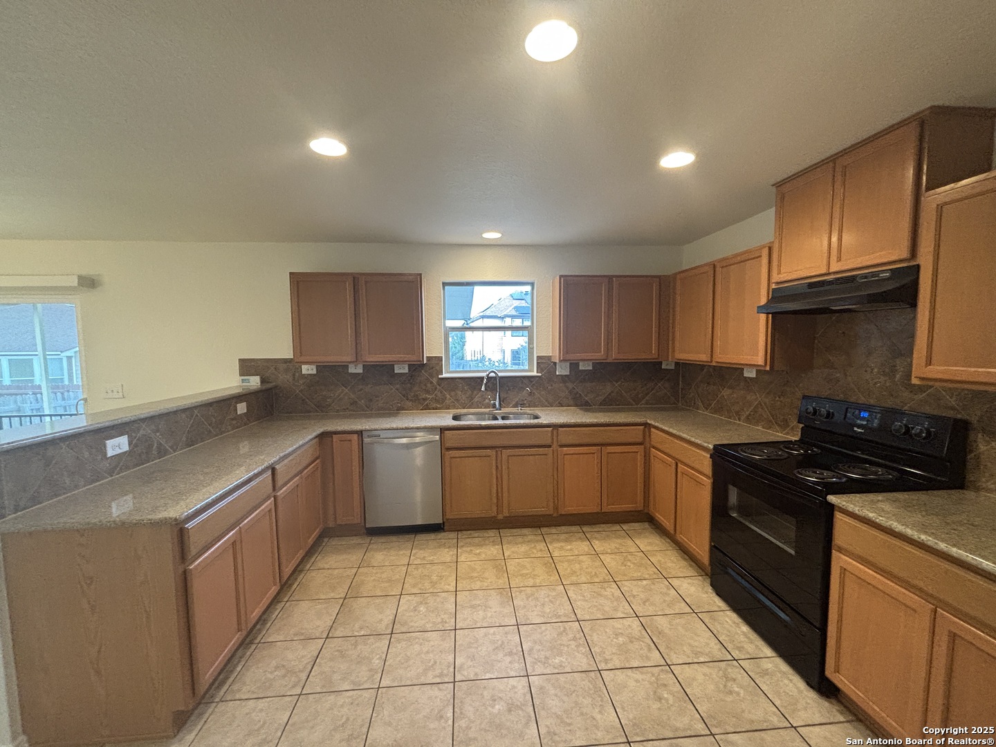7370 Azalea Square San Antonio, TX 78218 - Photo 21 of 38 a large kitchen with a stove a sink dishwasher and a refrigerator