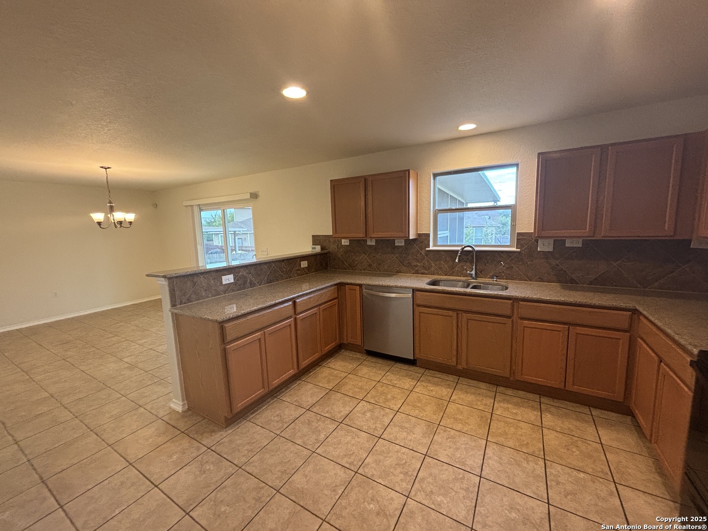 7370 Azalea Square San Antonio, TX 78218 - Photo 22 of 38 a kitchen with stainless steel appliances granite countertop a sink and cabinets