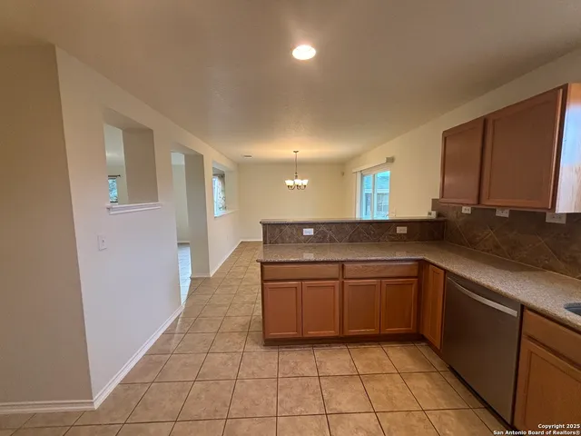 a kitchen with stainless steel appliances granite countertop a sink and cabinets