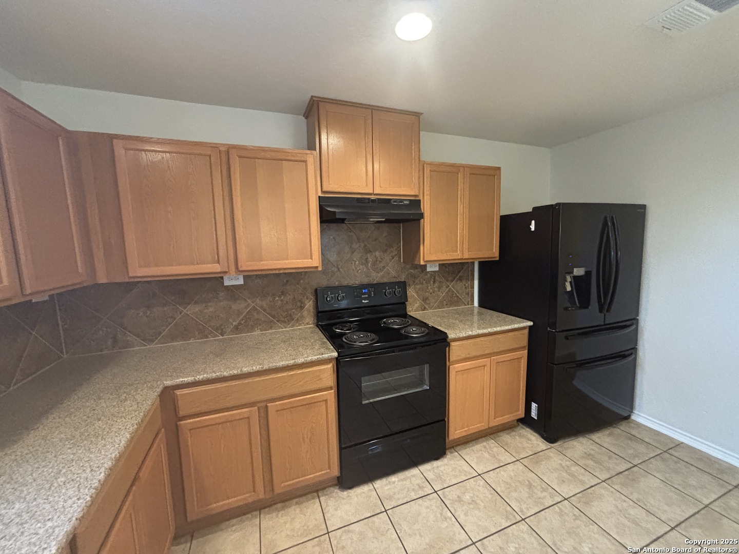 7370 Azalea Square San Antonio, TX 78218 - Photo 24 of 38 a kitchen with a stove top oven and cabinets