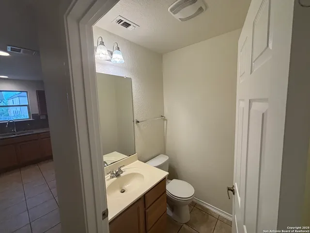 a bathroom with a toilet a sink and mirror