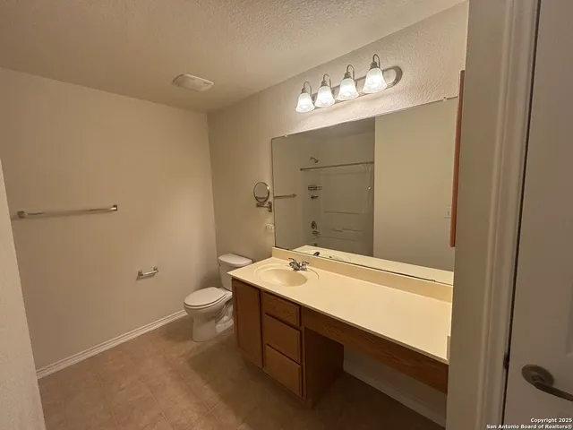 a bathroom with a shower and a toilet