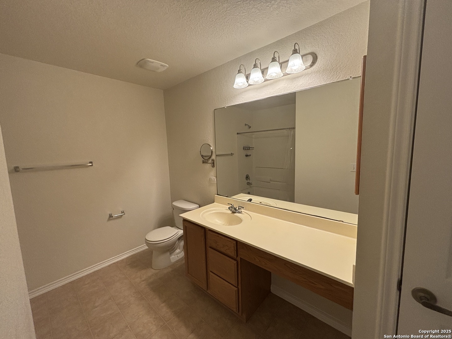 7370 Azalea Square San Antonio, TX 78218 - Photo 28 of 38 a bathroom with a sink a toilet and a mirror