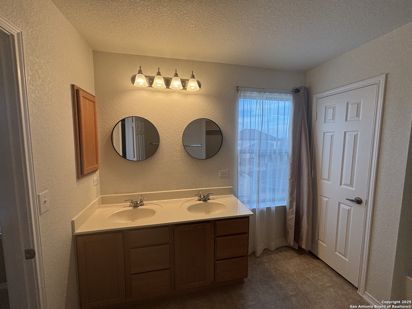 7370 Azalea Square San Antonio, TX 78218 - Photo 35 of 38 a bathroom with a sink and a mirror