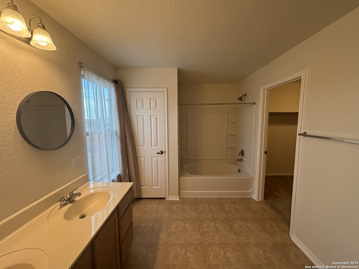 7370 Azalea Square San Antonio, TX 78218 - Photo 36 of 38 a bathroom with a sink and a mirror