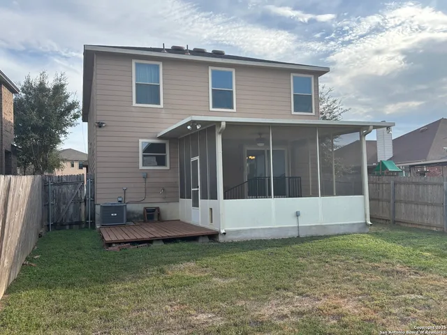 a view of a house with backyard and sitting area