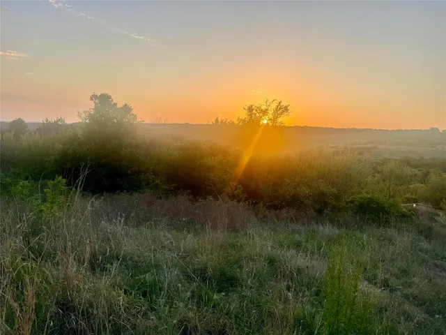 a view of a lake and green valley