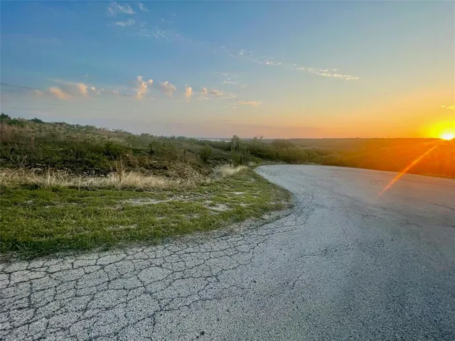 a view of a field with an ocean