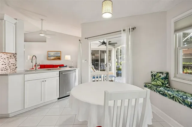 a en suite bathroom with a granite countertop double vanity sink a mirror and a bathtub