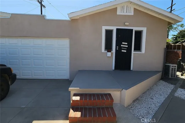 a view of a hallway with wooden floor and a potted plant