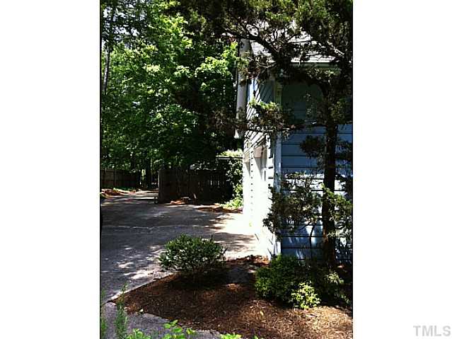 225 Carriage Trail Raleigh, NC 27614 - Photo 3 of 25 a view of a yard with plants and a tree